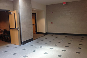 Showing doors at the end of the hallway which is where you take a left.
